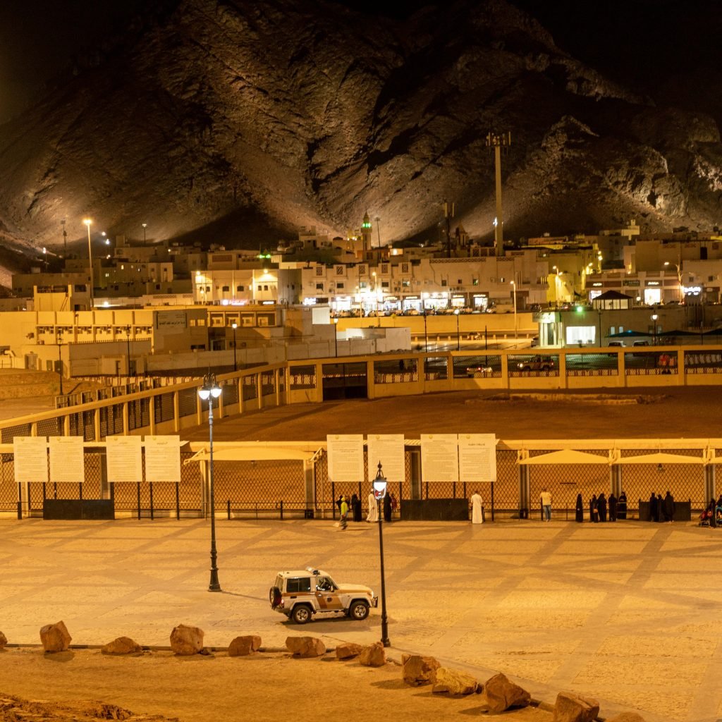Illuminated Medina landscape with mountains and city lights at night.