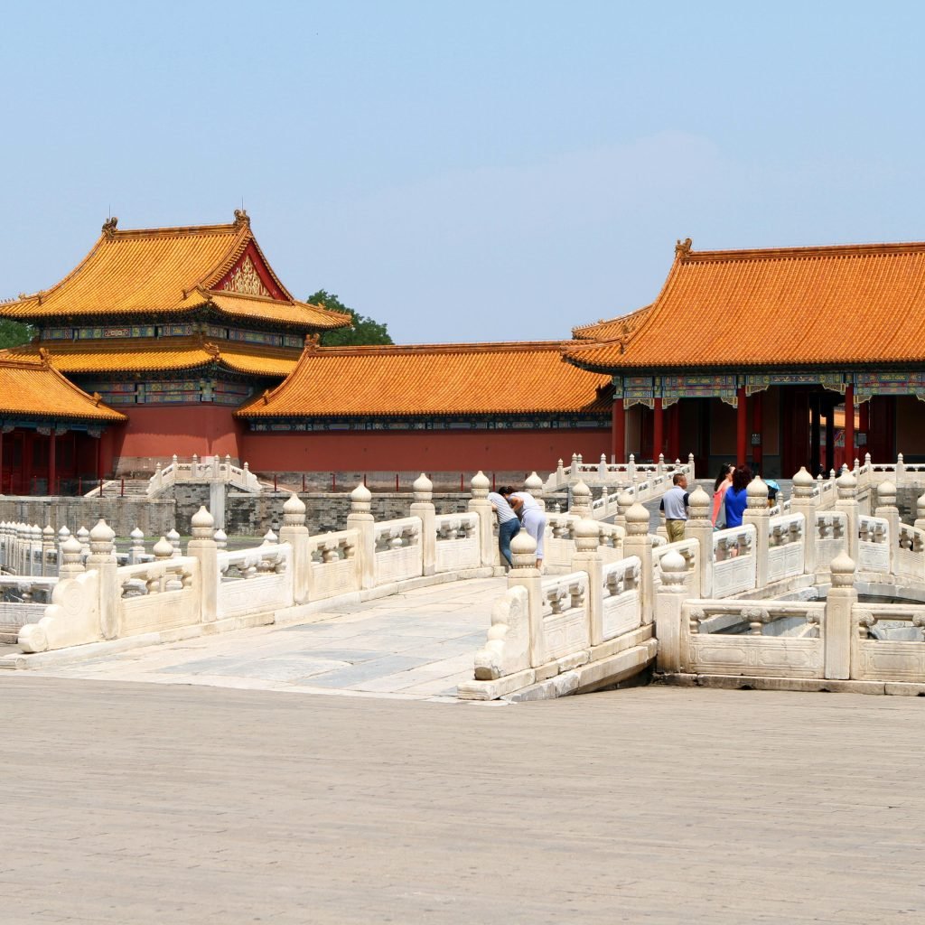 The stunning Forbidden City in Beijing featuring ancient Chinese architecture with tourists exploring.