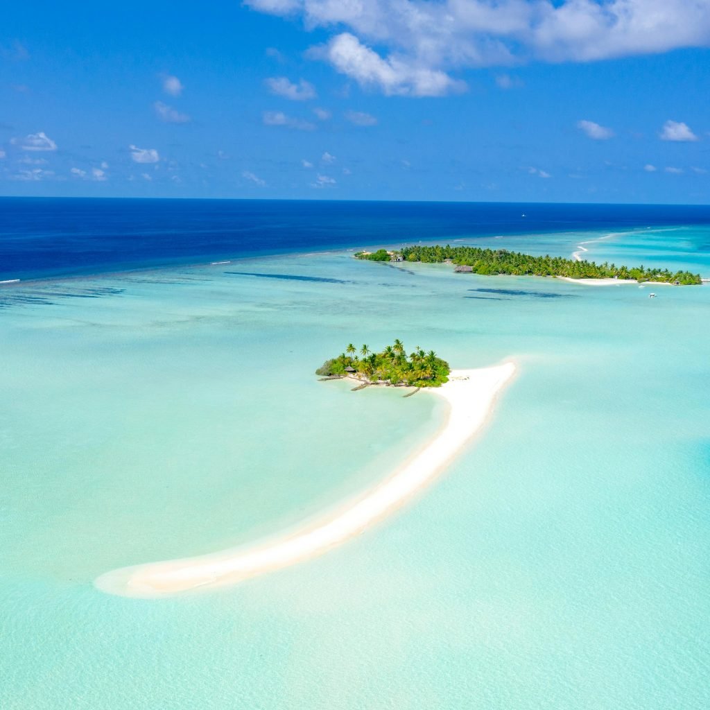 A breathtaking aerial shot of a tropical island with clear turquoise waters in the Maldives.